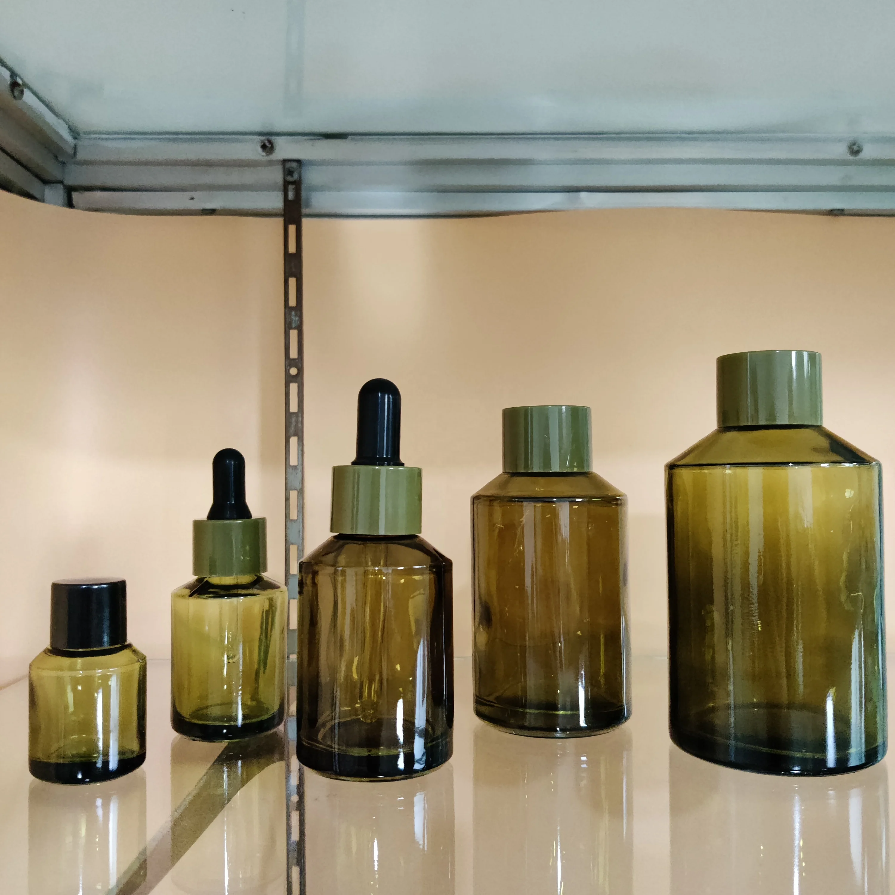 Factory hot sell cosmetic olive green slant shoulder glass lotion bottle with back pump and dropper