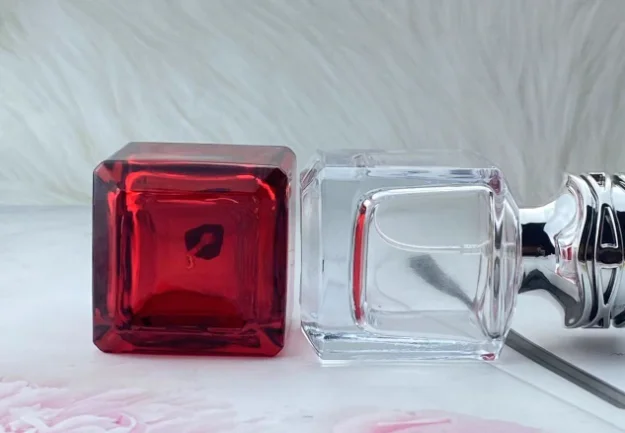 Hot Sale 50ML square Custom Color Red Transparent Perfume Glass Bottle with Flower-shaped Gold and Silver Lid