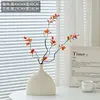 Two autumn buds in a plain vase