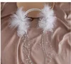 Accessorio per capelli con piume