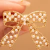 XP003 Lazo pequeño dorado con perlas de imitación ahuecadas
