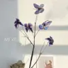 dead branches, butterflies, blue and purple