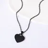 Cadena negra con dije de corazón en forma de abanico de 20 mm + cruz plana.