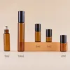 Amber bottle + steel roller ball + black aluminum cap