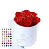 7 roses in white round box