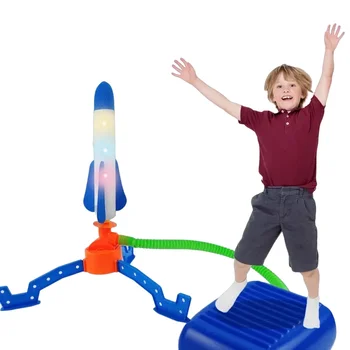Children's feet step on a small rocket that soars into the sky Outdoor glowing catapult that flies into the sky flashing rocket