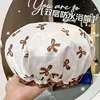 White shower cap with bow