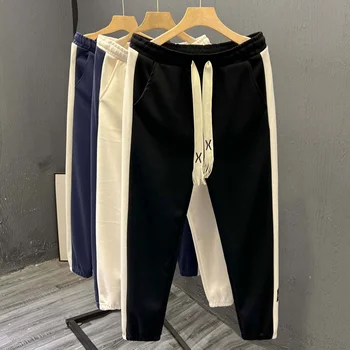 High-end men's casual pants with striped splicing. Fashionable and handsome men's sports pants new style.