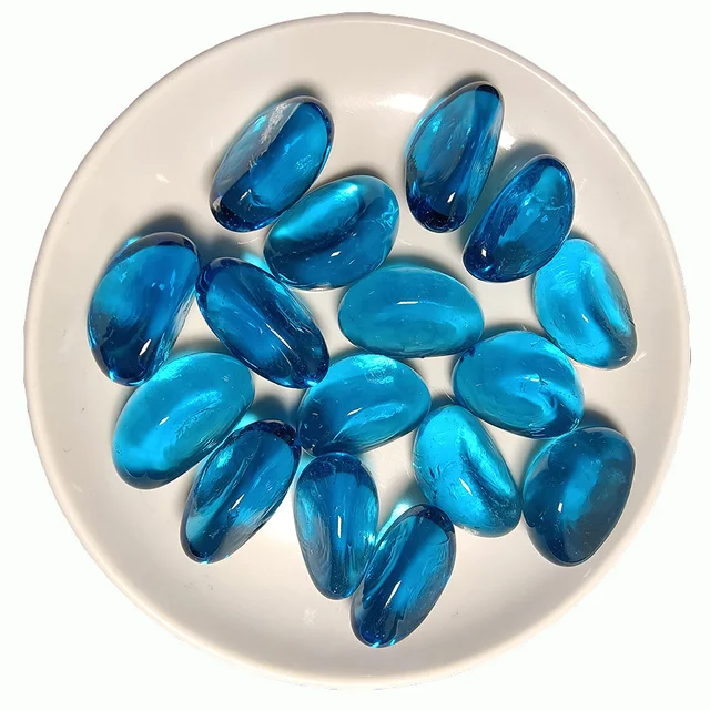 A sea blue cashew-shaped glass bead used for aquarium landscaping or firepot decoration  glass stone