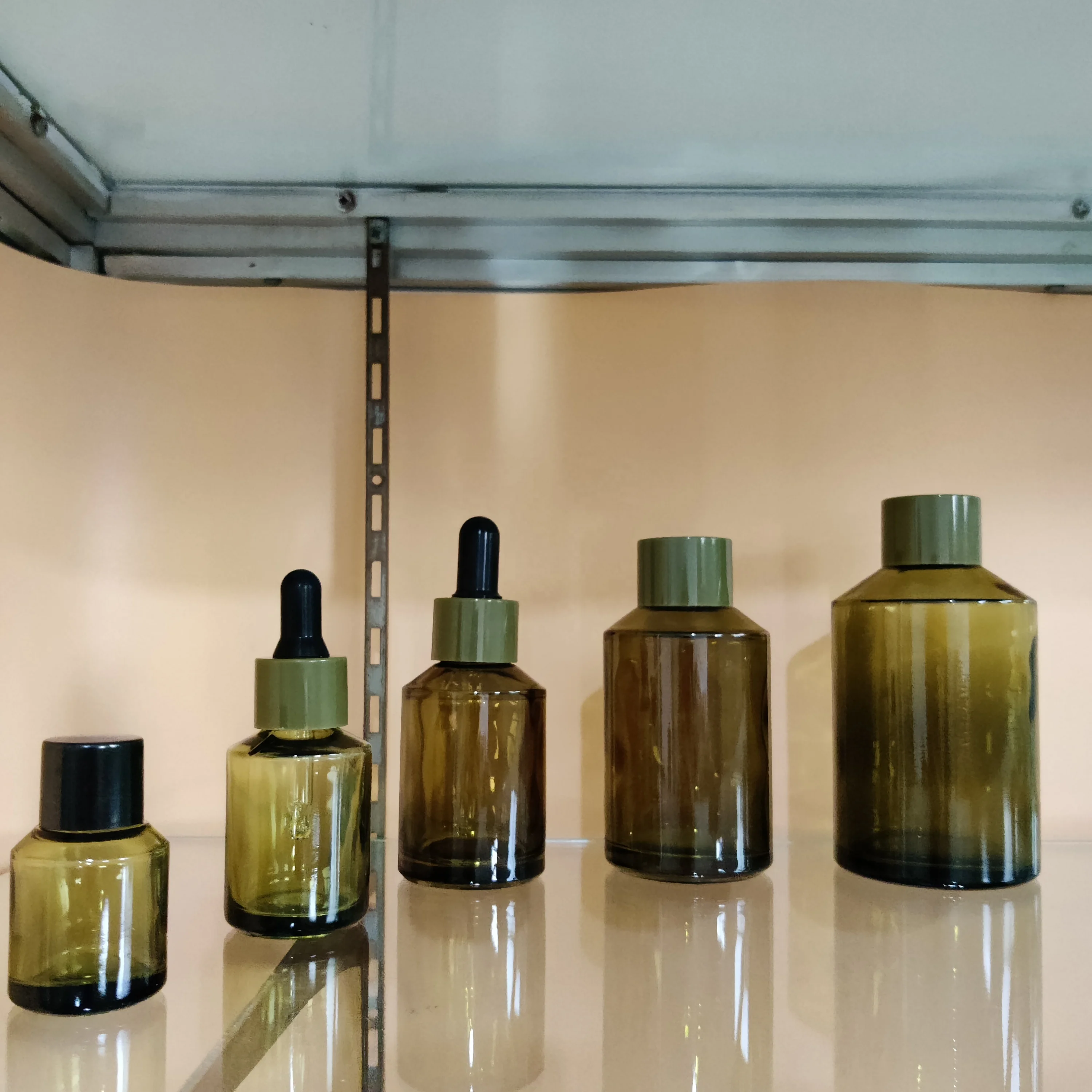 Factory hot sell cosmetic olive green slant shoulder glass lotion bottle with back pump and dropper