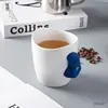 White cup with blue handle