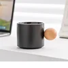 Black coffee cup with wood holder