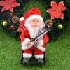 Père Noël jouant du violon et de la chaise à bascule