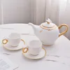 white 1 pot,2 cup and 2 saucer