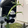 Panda que abraza bambú