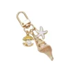 Llavero de concha, caracola, estrella de mar, concha marina y perla