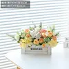White wood fence with roses, 1 white and 1 orange.