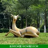 Copper-colored lying female deer