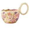 Tazza gialla con decorazioni floreali