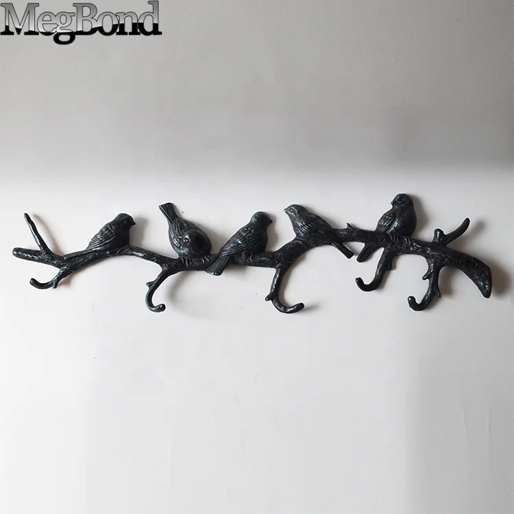 Cast iron bird on branch wall