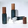 Dark green bottle with silver nozzle and black walnut wood cap