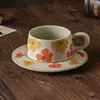 Small flower-shaped terracotta cups and saucers