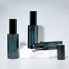 Dark green bottle with black nozzle cover
