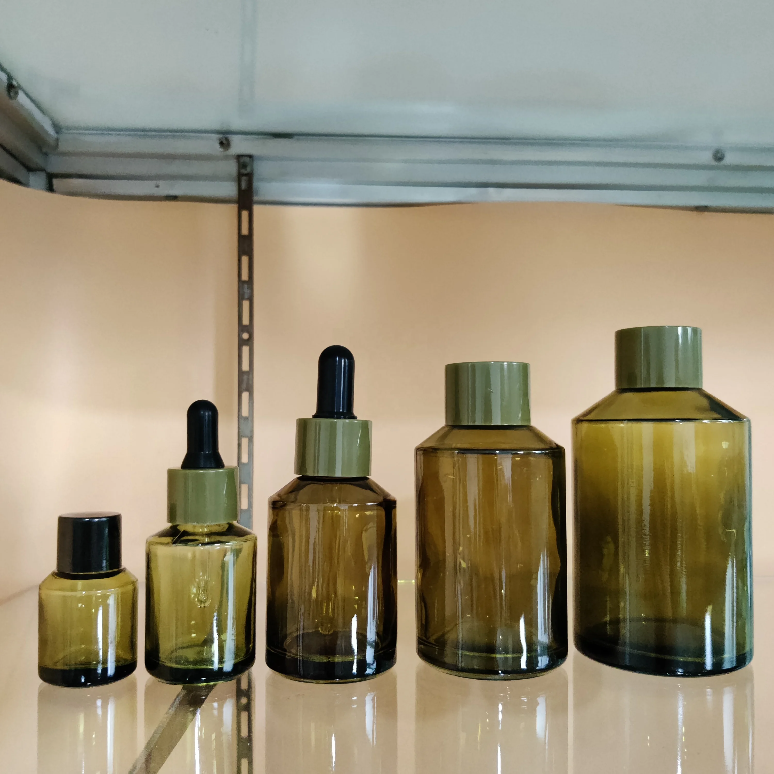 Factory hot sell cosmetic olive green slant shoulder glass lotion bottle with back pump and dropper