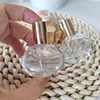 Clear glass bottle with steel roller & gold cap