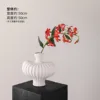 Textured vase with white flame lilies and a single red lily