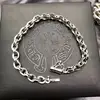 Catena a maglia ovale con logo inciso, intarsi in cristallo, argento antico e nero