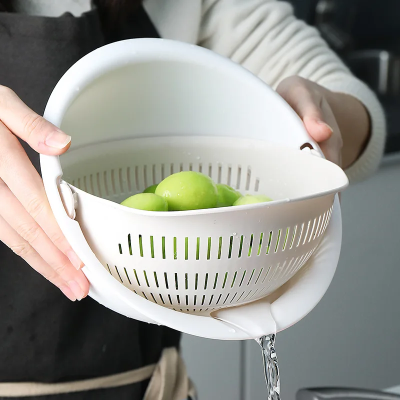 Il bacino di scarico del doppio cestello per la lavatrice creativo per la casa può ruotare il cestello del filtro per verdure in plastica per il lavaggio della cucina del bacino della frutta