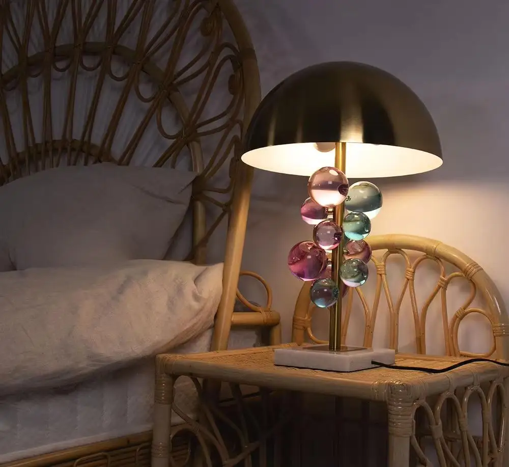 The Globo Table Lamp Consists of a Series of Glass Balls Floating on a Slender Metal Pole with a Metal Dome on Top to Make the
