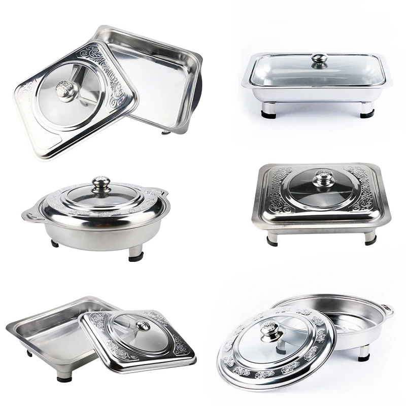 Row of stainless hotel pans on food warmers with various meals.  Self-service buffet table. Celebration, party, birthday or wedding concept.  Stock Photo