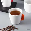 White cup with orange handle