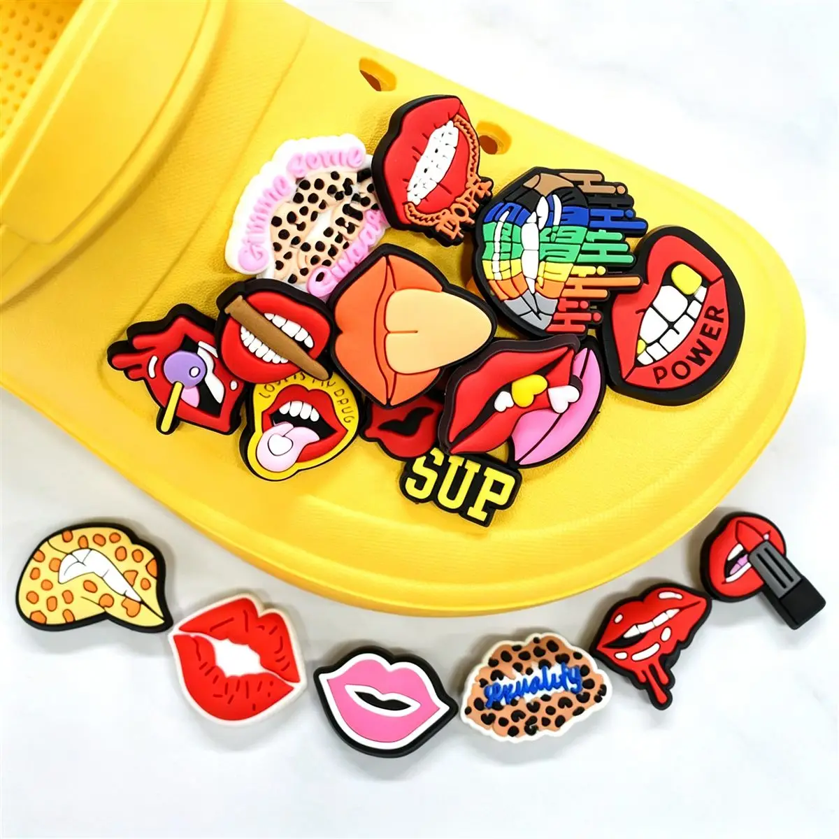 Pop art lips themed shoe charms on yellow clogs