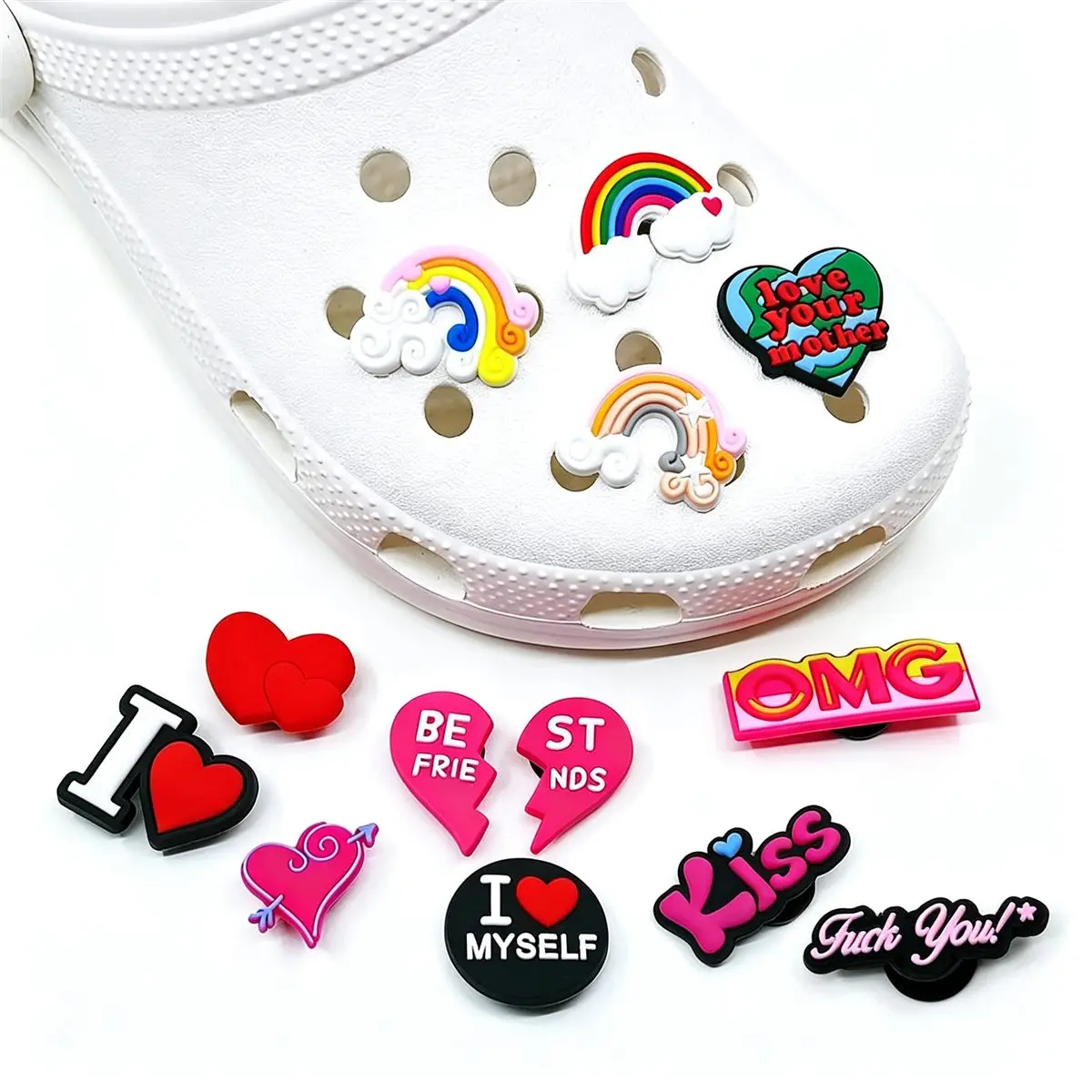 Heart and word themed shoe charms on white clogs