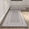 Gold-woven kitchen mat - cloud and water border
