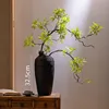 A 32.5cm ceramic vase with a maple leaf.