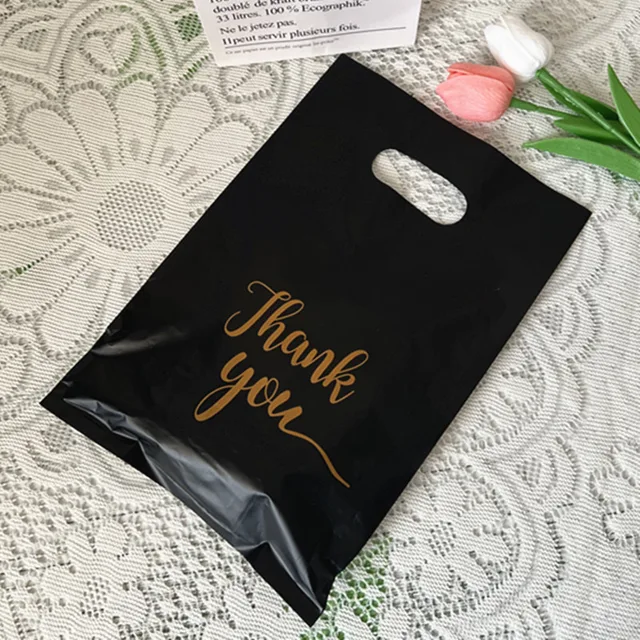 Yiwu Factory Cross-Border Wholesale Black PE Gift Bag Plastic Handbag with Four-Finger Design Gravure Printing Heat Sealing