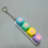Four-button white shell - silicone cat paw pattern in blue, green, yellow, and purple.