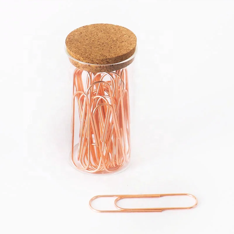 office rose gold paper clips and binder clips in glass jar
