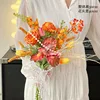 Orange short-stemmed iris, dried small roses, coral grass, hand-