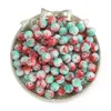 Perles en porcelaine flocon de neige - rouge et vert (8mm)