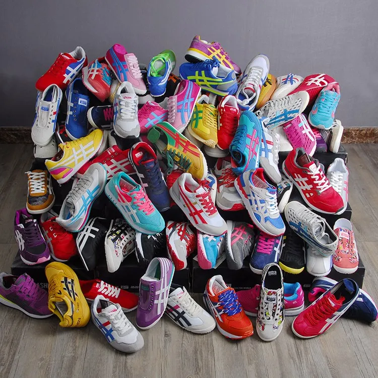 A lot of mix used soccer shoes container of used clothes