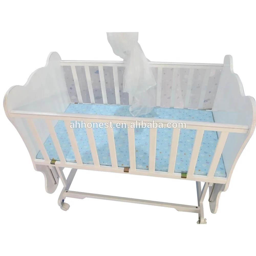 white wooden baby cot