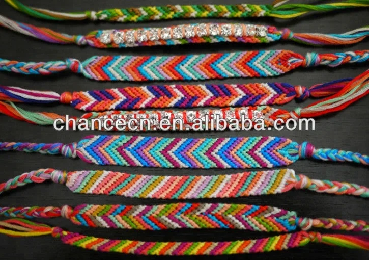 Multi-colored woven friendship bracelets handmade of embroidery bright  thread with knots on light background Stock Photo - Alamy