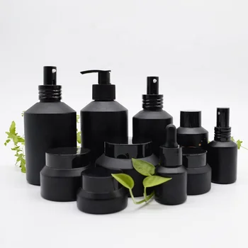 hot sale cosmetic glass bottle and jar with black frosted amber color and pump spray dropper for essential oil serum packaging