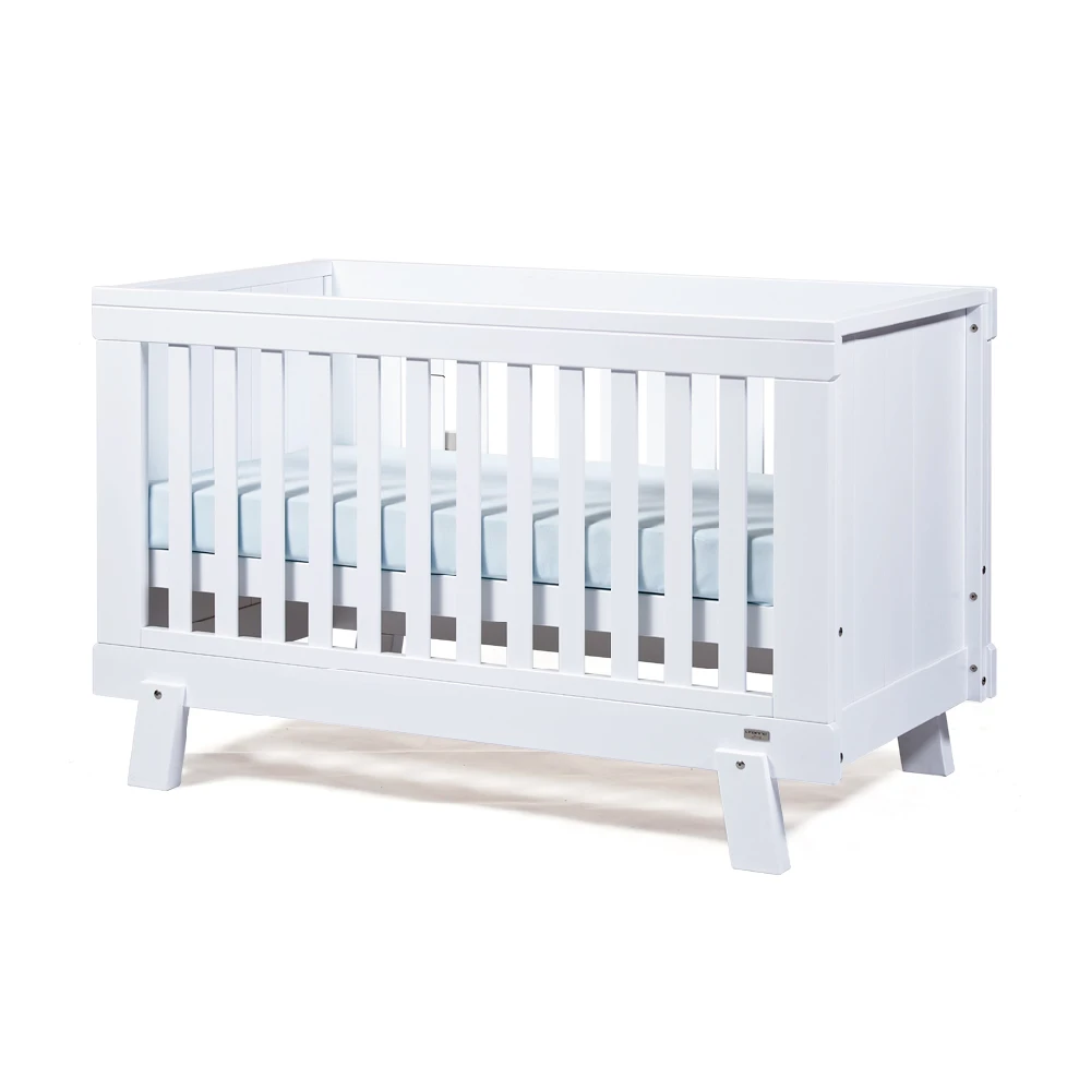 white crib with wood bars