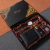 6 articoli: orologio, portafoglio in pelle, profumo, portachiavi, penna, confezione regalo